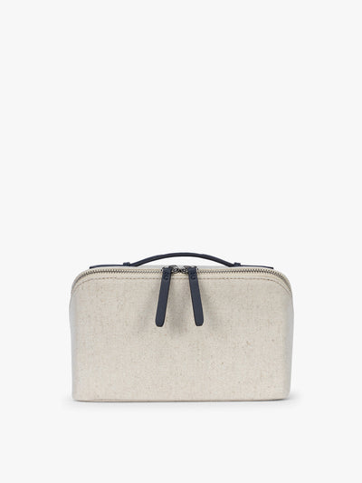 CALPAK Colette Lay-Flat Canvas Toiletry Bag in beige canvas material and blue finishing; CLTB2601-NATURAL-NAVY view 1