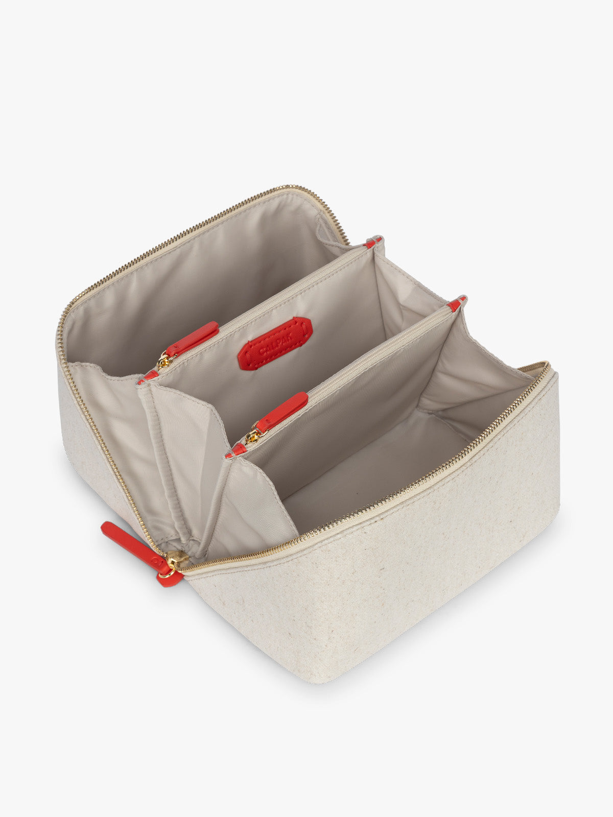 Opened CALPAK Colette Lay-Flat Canvas Toiletry Bag in beige canvas material and red finishing; CLTB2601-NATURAL-TOMATO