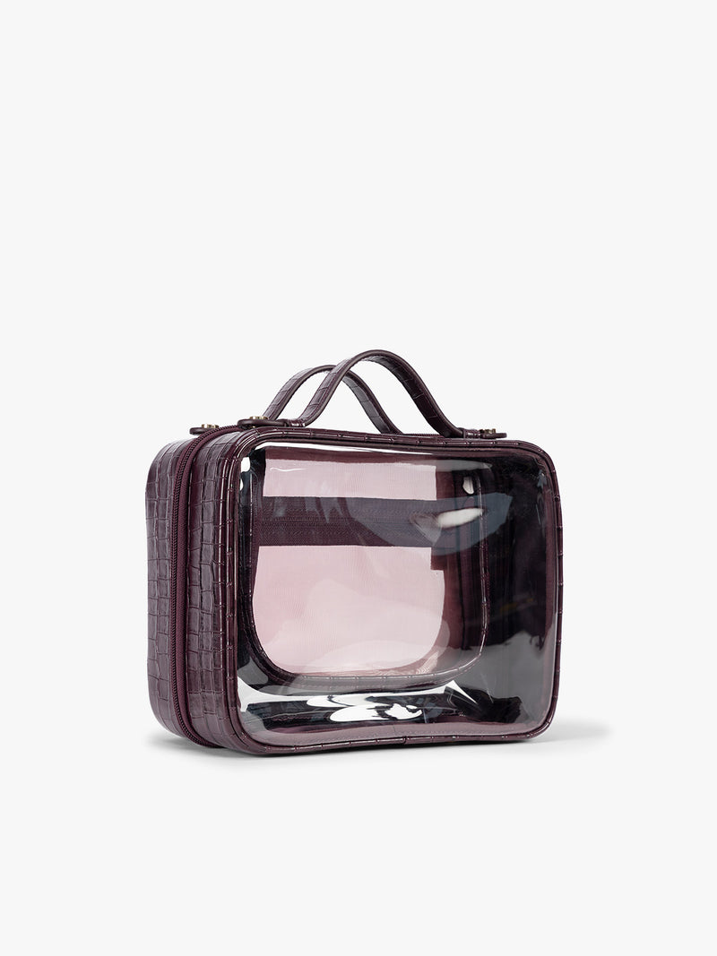 Side view of CALPAK Medium Clear Cosmetics Case that is a transparent pouch with a deep red Dark Cherry in crocodile-embossed