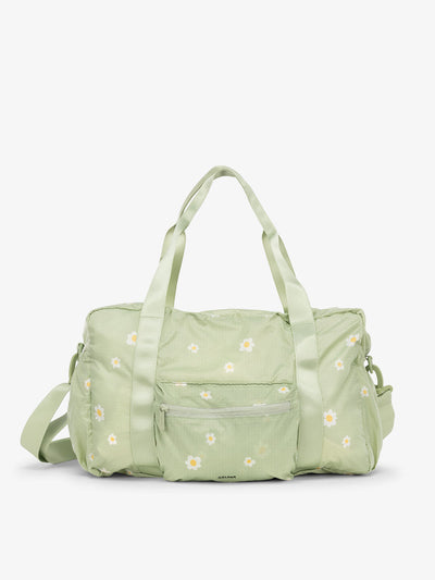 CALPAK Compakt duffel bag with removable crossbody strap and water resistant fabric in light green floral print; KDB2001-DAISY view 1