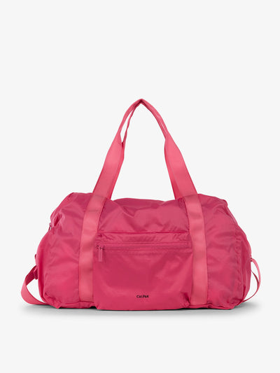 CALPAK Compakt duffel bag with removable crossbody strap and water resistant fabric in dragonfruit; KDB2001-DRAGONFRUIT