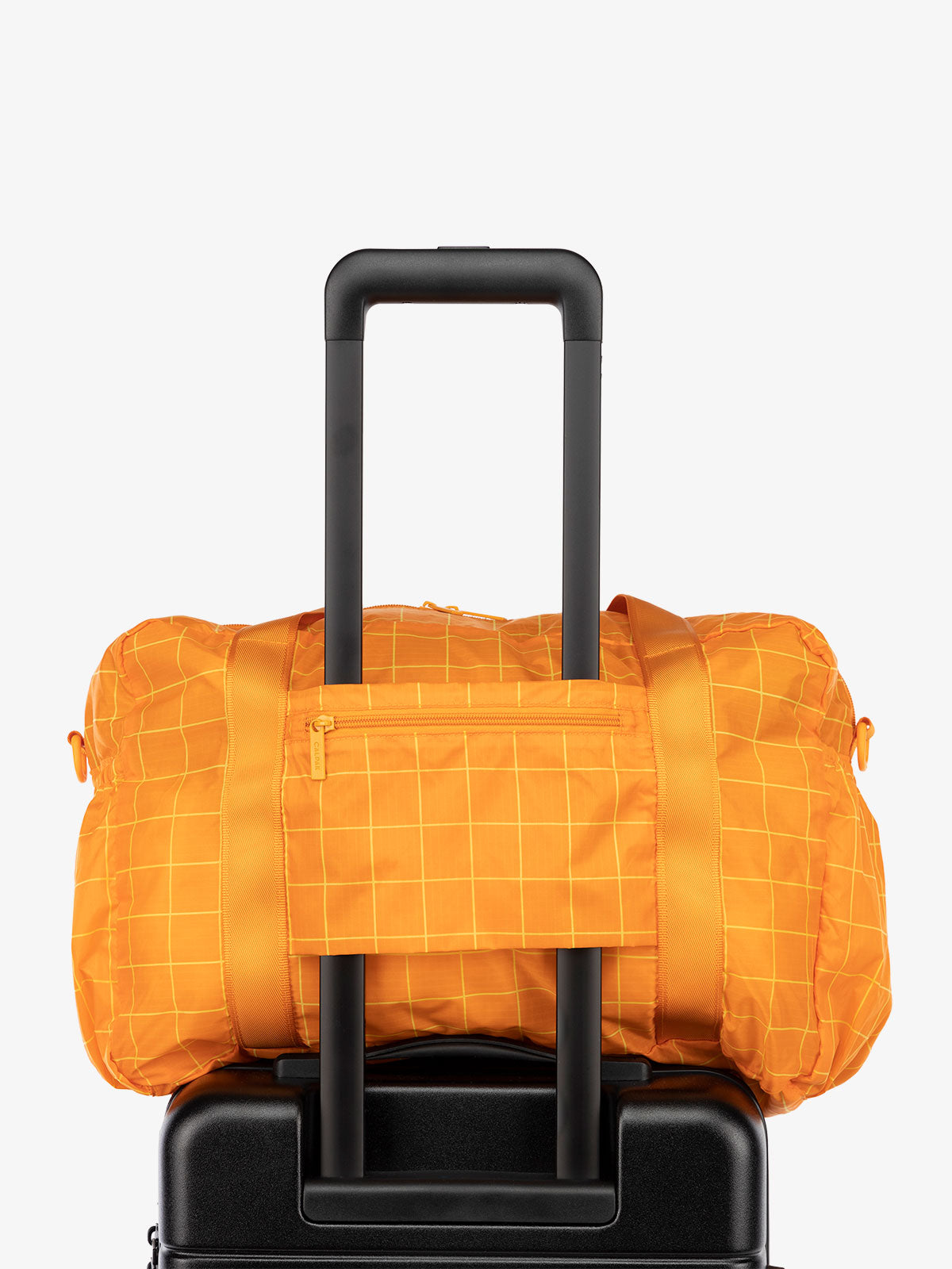 CALPAK Compakt nylon duffle bag with trolley sleeve in orange grid