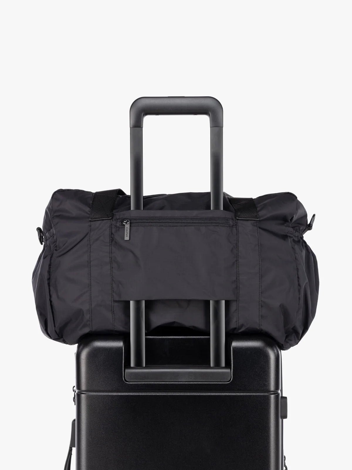 Black CALPAK Compakt Duffel Bag part of compakt duo with trolley luggage sleeve