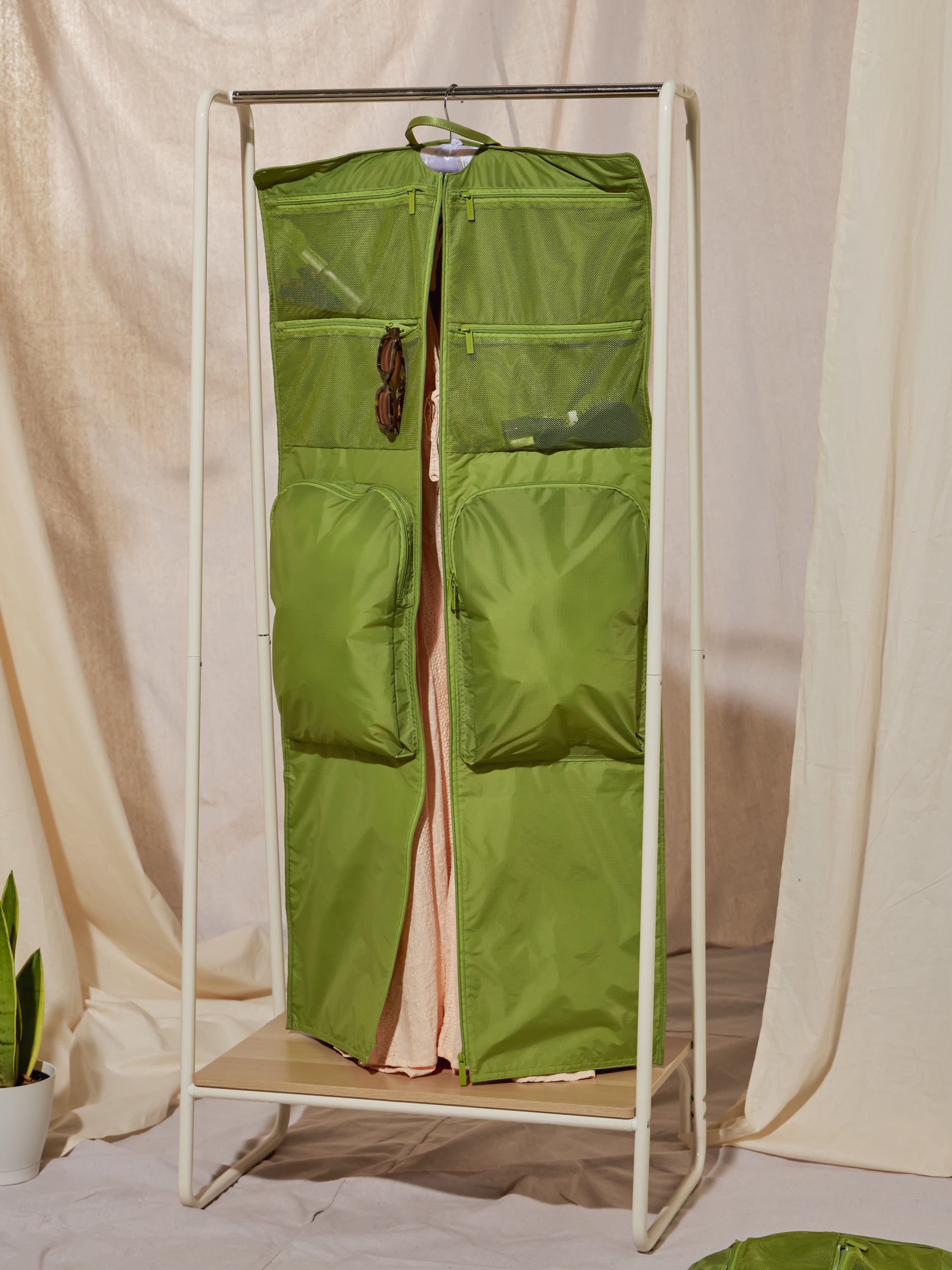 CALPAK Compakt large hanging garment travel bag with mesh pockets and water resistant exterior in palm green