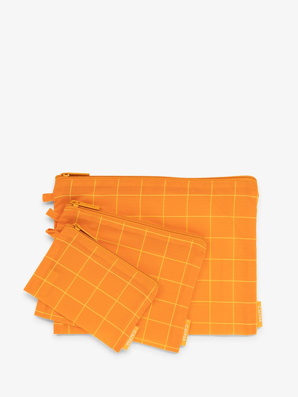 CALPAK Compakt zippered pouches in orange grid
