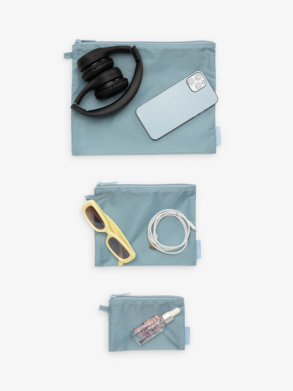 CALPAK Compakt 3 piece zippered pouch set in 3 sizes with water resistant material in powder blue