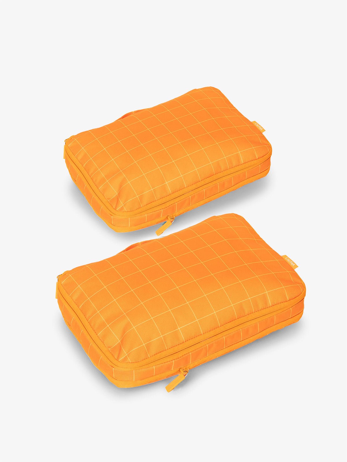 CALPAK compression packing cubes in orange grid