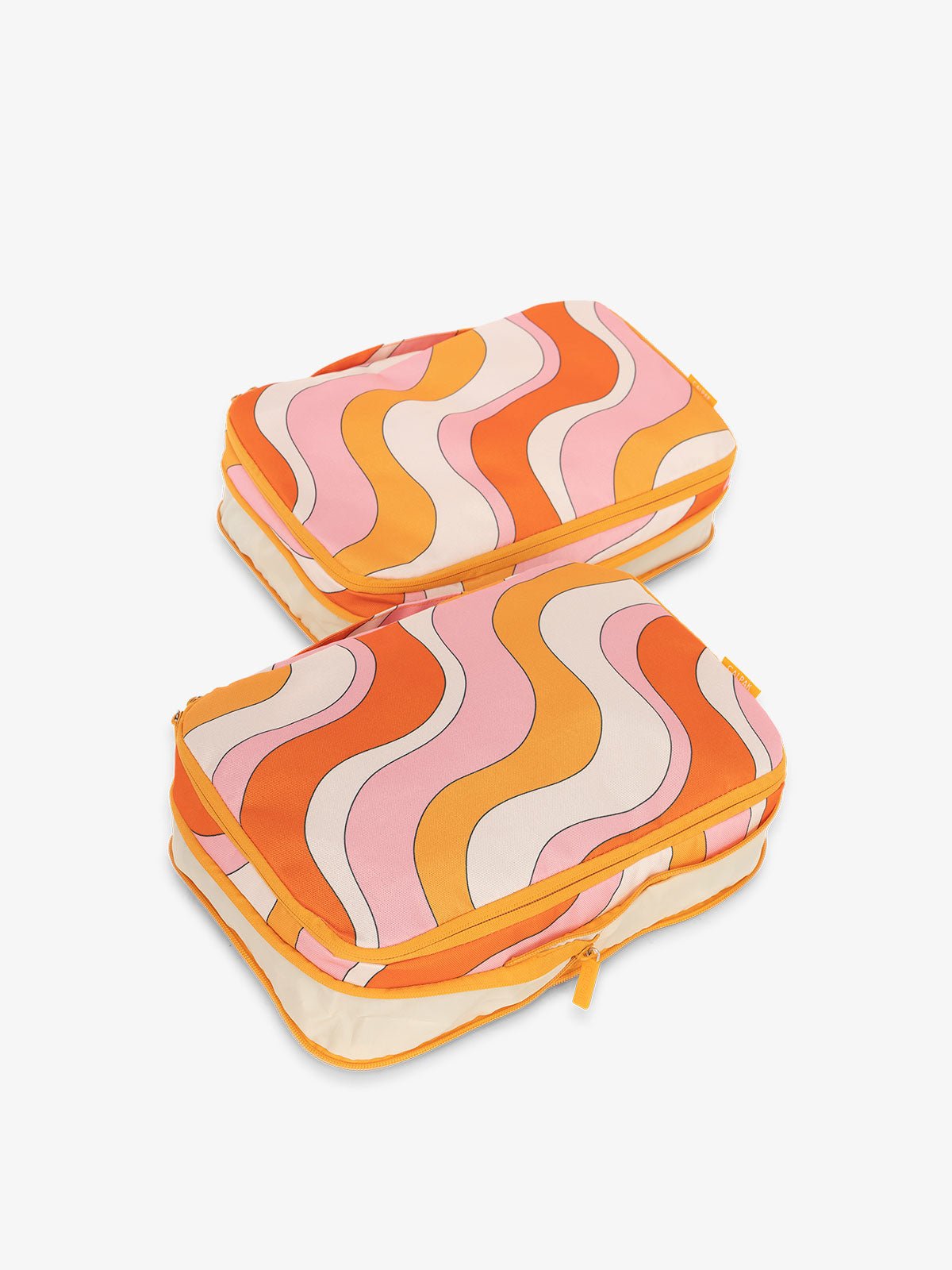 CALPAK compression packing cubes with handles in wavy orange print