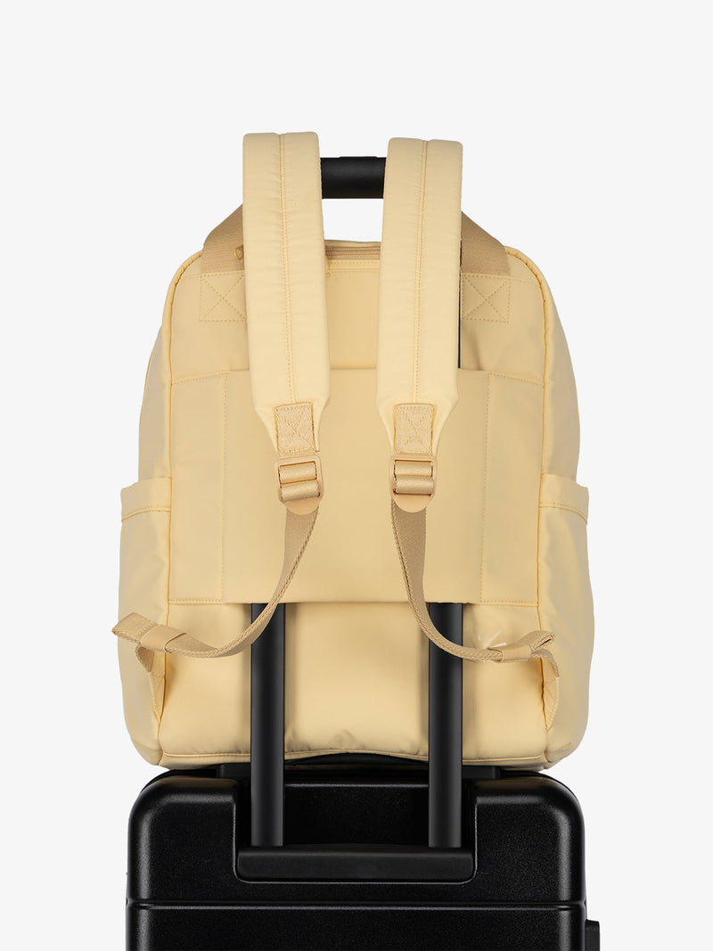 Luggage trolley sleeve of CALPAK Connect Laptop Backpack in sunshine yellow