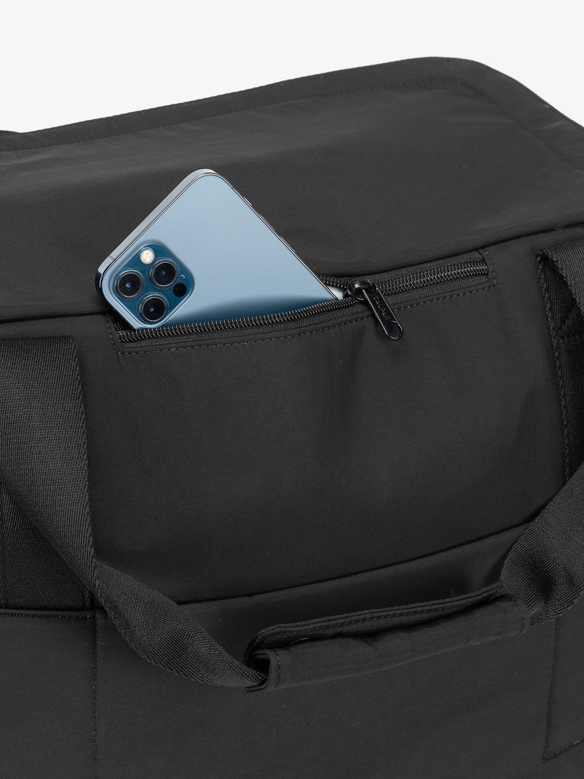 Zippered phone pocket of CALPAK Connect Laptop Duffel in black; DCN2401-BLACK