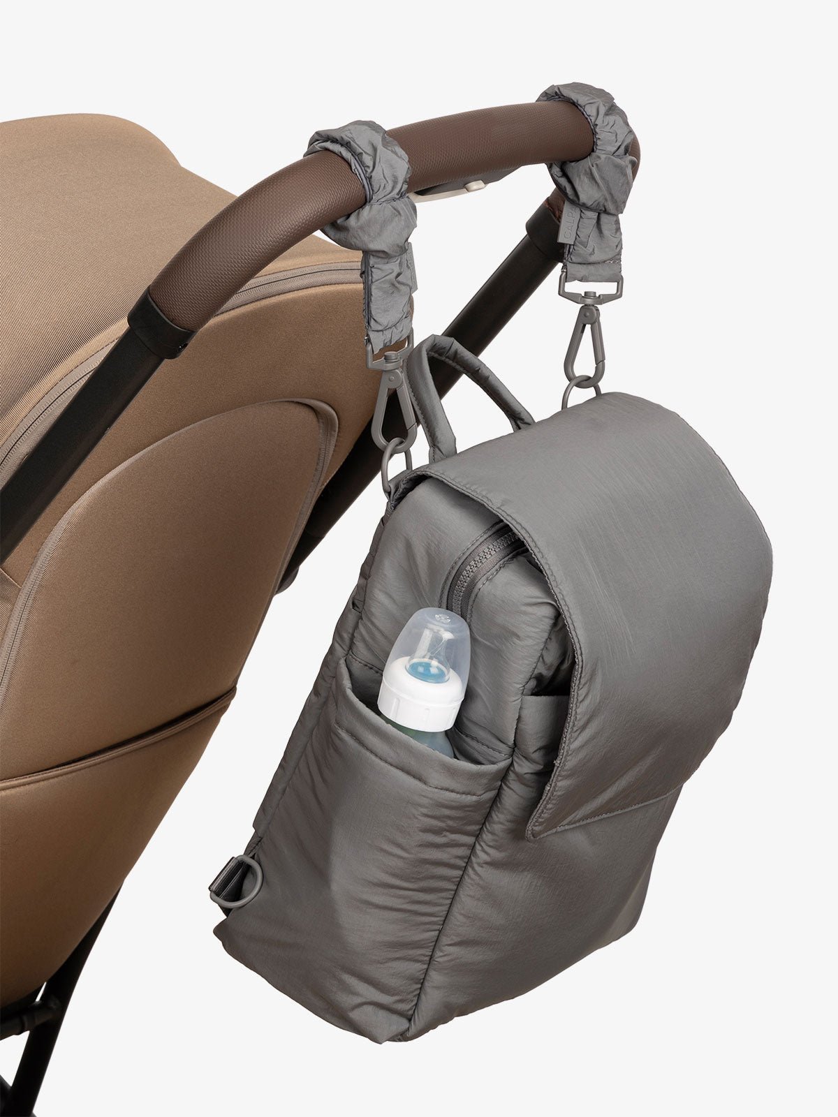 CALPAK Convertible Mini Diaper Backpack attached to stroller by CALPAK Stroller Straps in slate gray