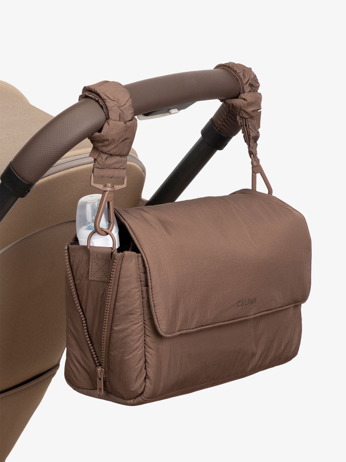 CALPAK Convertible Stroller Caddy Crossbody with included stroller straps in hazelnut brown