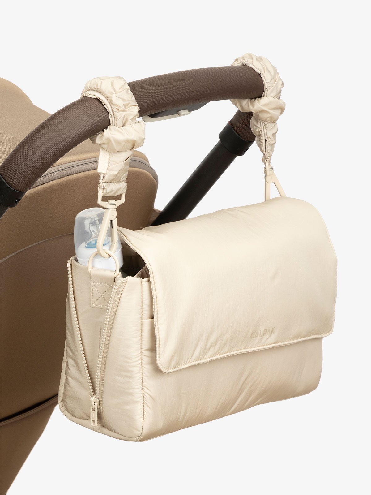 CALPAK Convertible Stroller Caddy Crossbody with included stroller straps in beige oatmeal