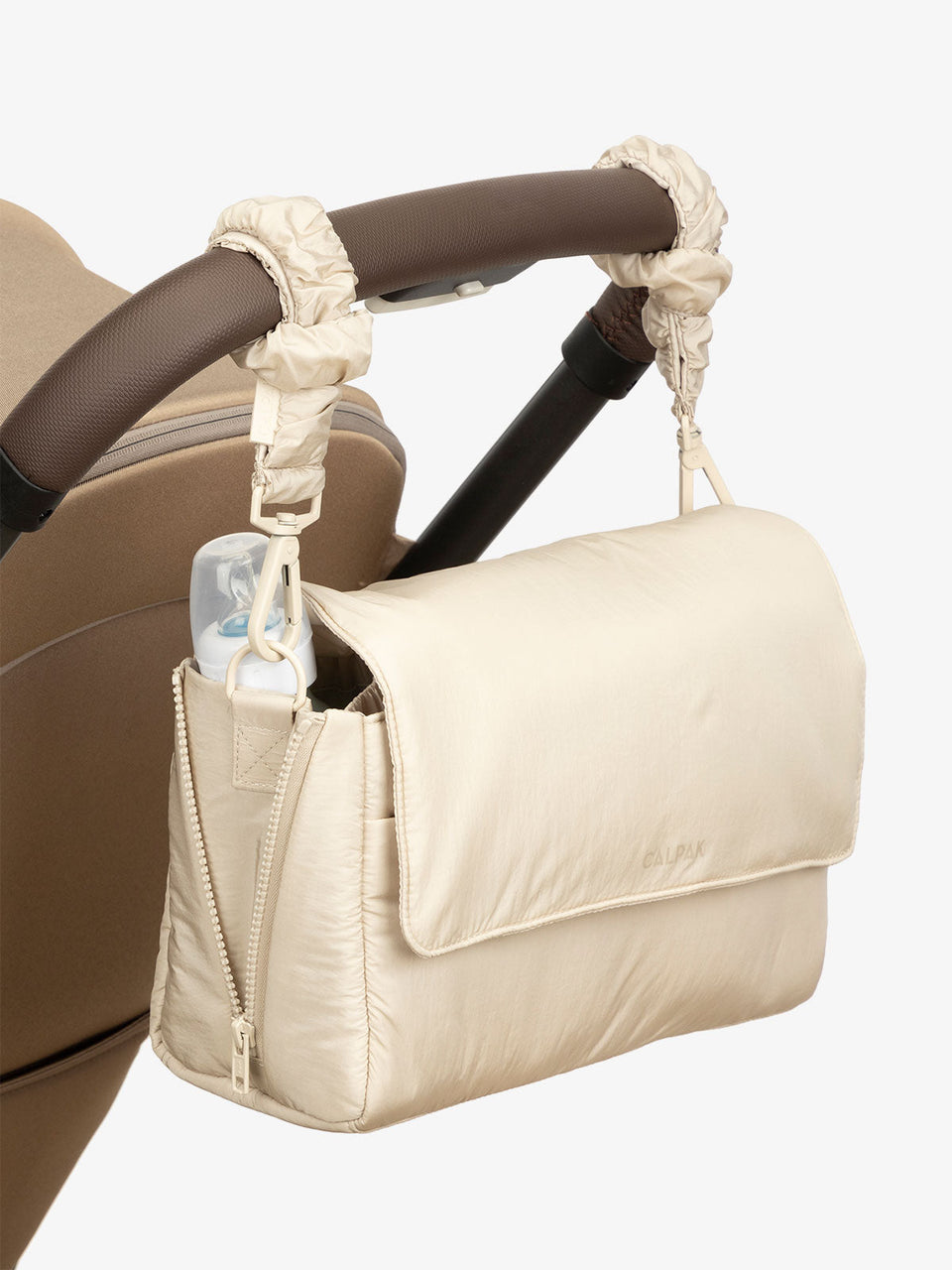 CALPAK Convertible Stroller Caddy Crossbody with included stroller straps in beige oatmeal; SCB2401-OATMEAL