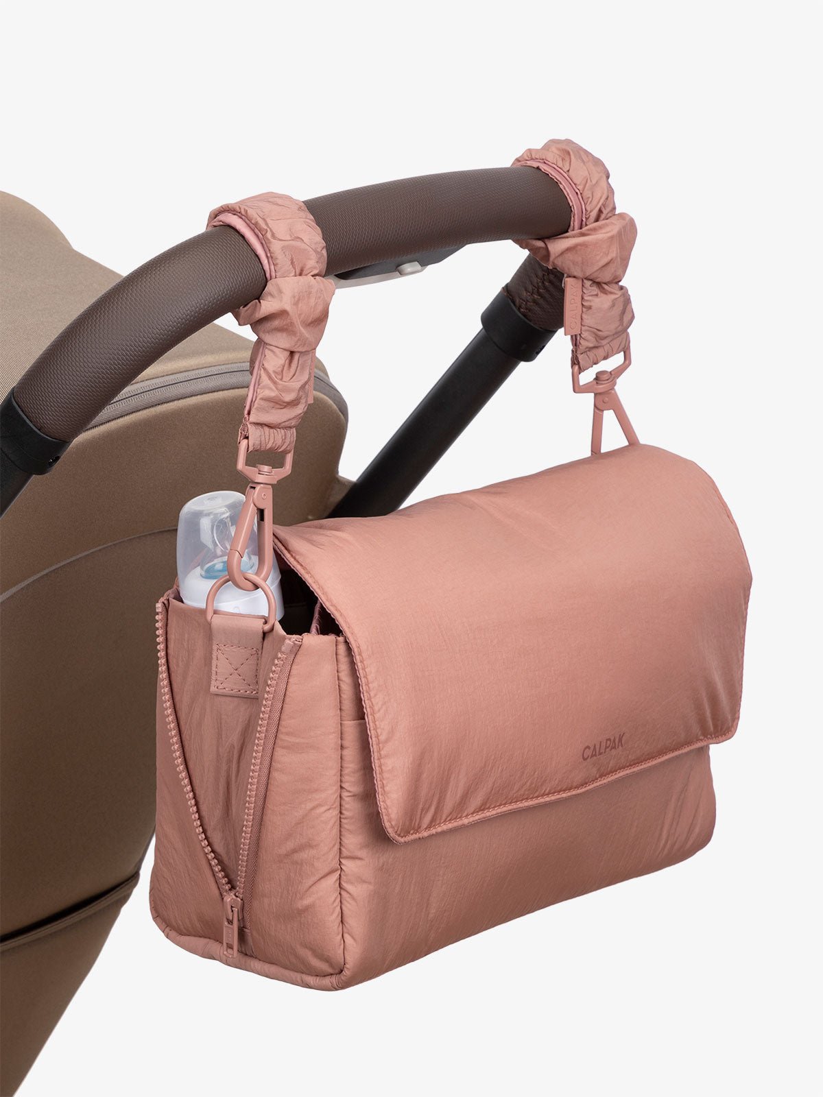 CALPAK Convertible Stroller Caddy Crossbody with included stroller straps in peony pink
