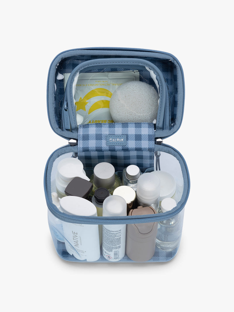 Toiletry products in CALPAK Clear Cosmetic Case in light blue French Blue