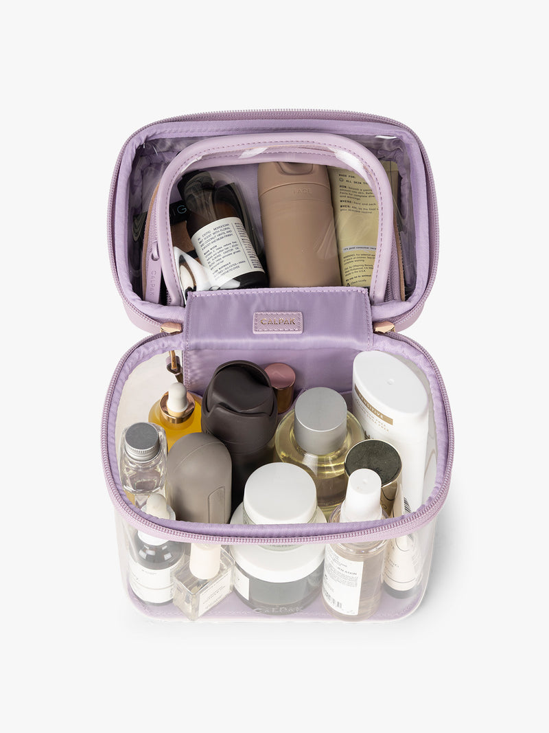 Makeup and toiletries in the CALPAK Clear Train Case in purple lavender