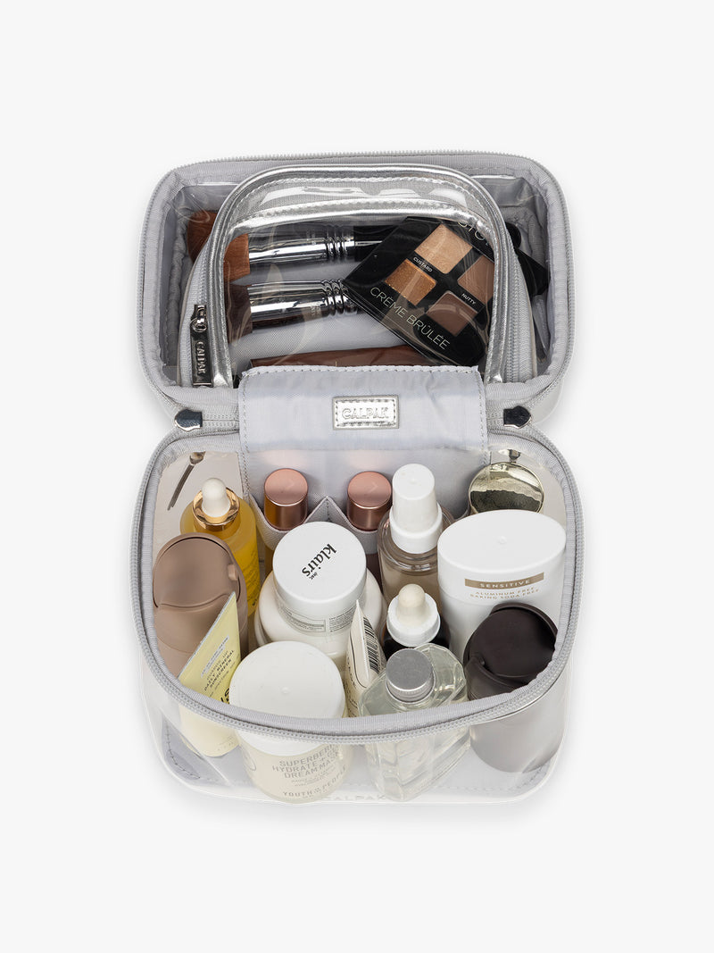 Toiletry items in CALPAK Clear Train Case in Silver