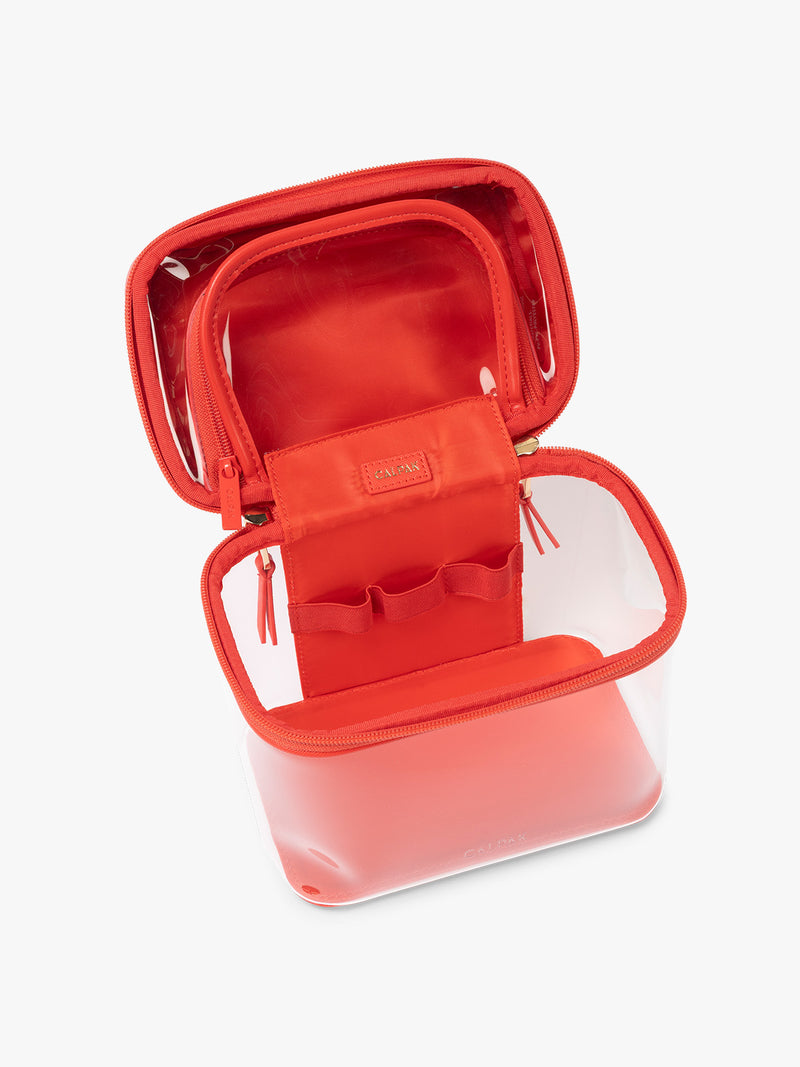 Opened view of CALPAK Clear Train Case in red Tomato