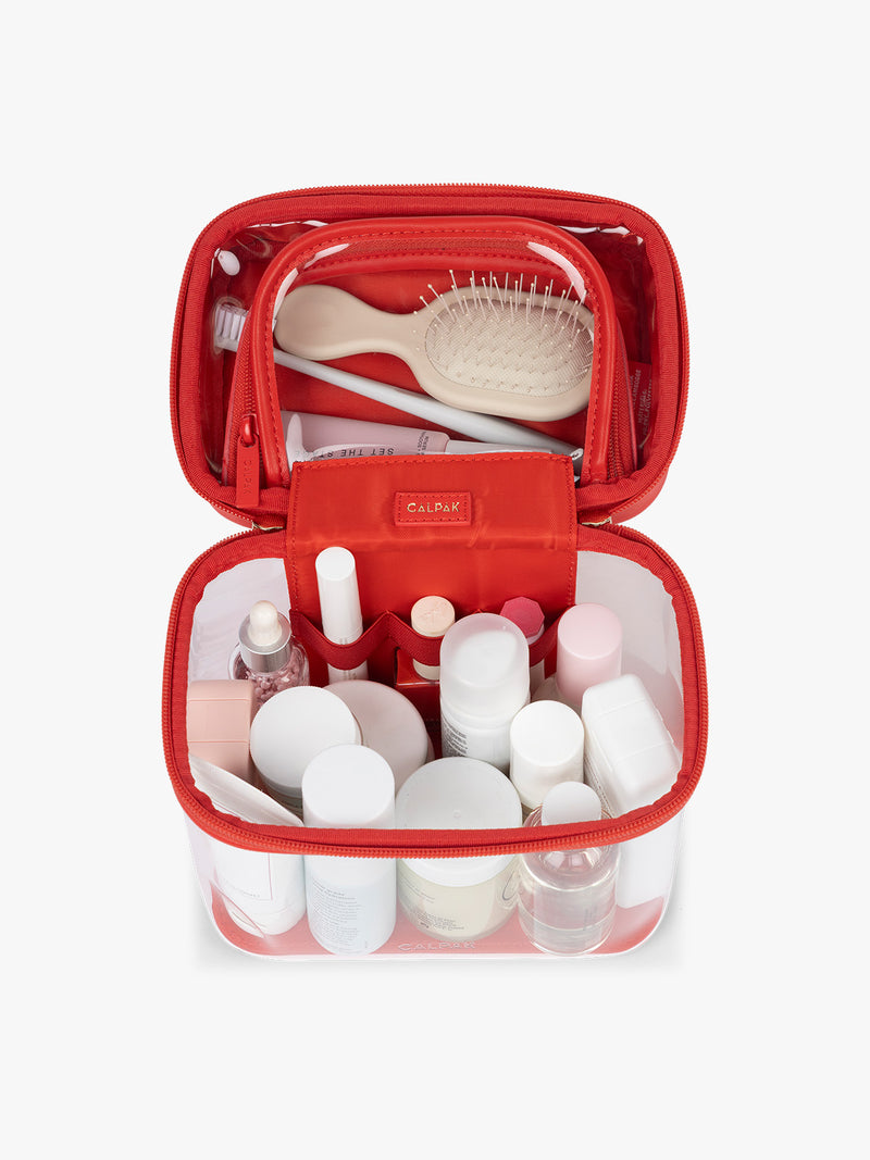 Toiletries inside CALPAK Clear Train Case in red Tomato