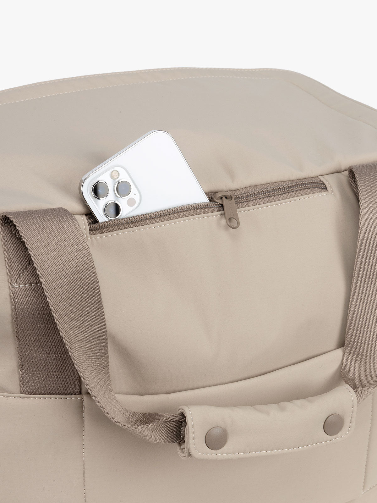 CALPAK Laptop Duffel in beige Greige phone pocket with white background; DCN2401-GREIGE