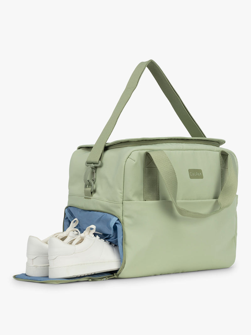CALPAK Laptop Duffel in light green Meadow showing shoe compartment with white background