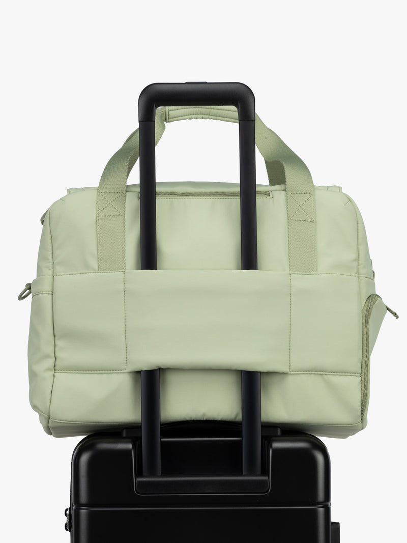 CALPAK Laptop Duffel in light green Meadow luggage trolley sleeve with white background
