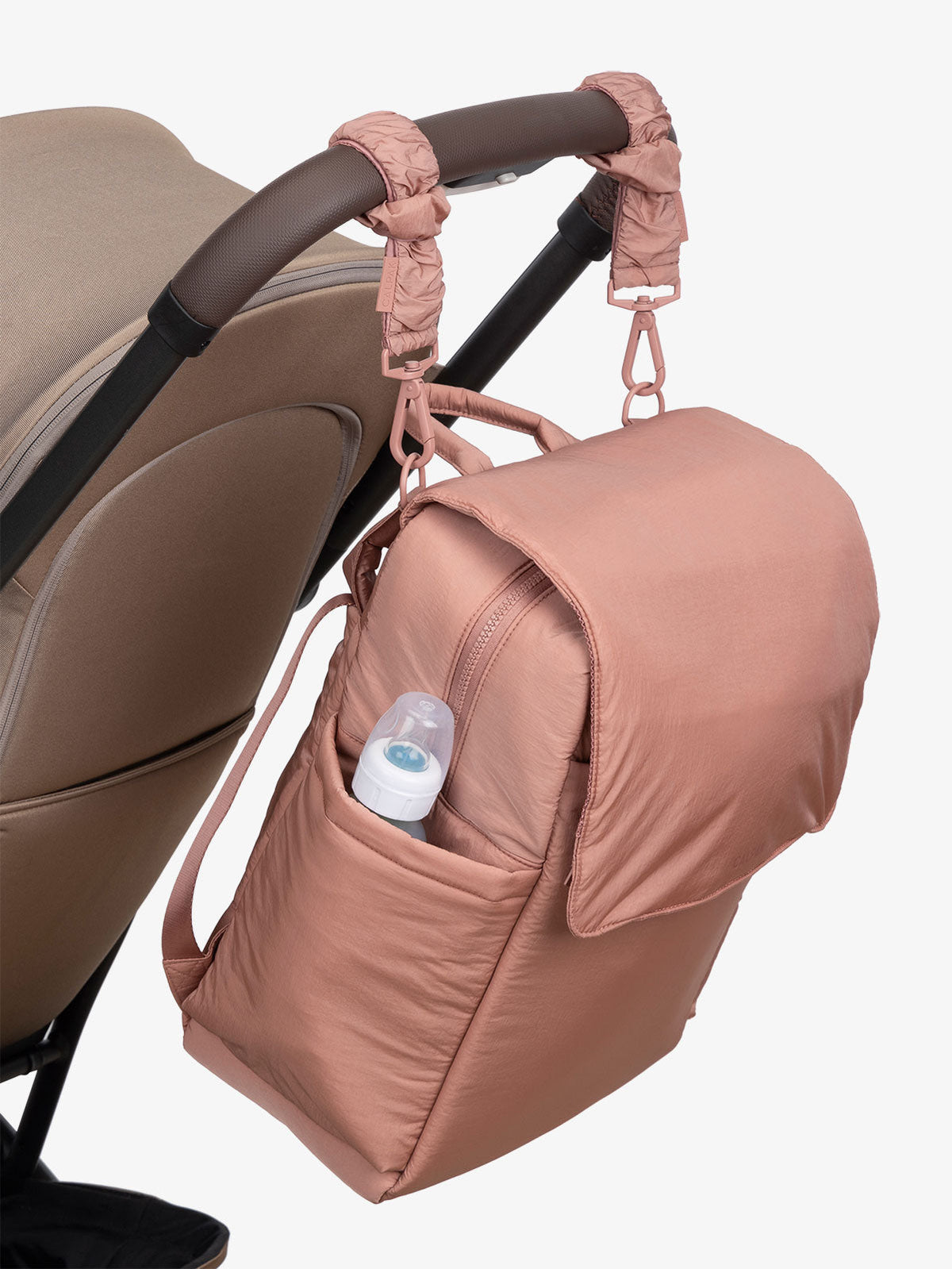 CALPAK Diaper Backpack with Laptop Sleeve attached to stroller by CALPAK Stroller Straps in peony; BPB2401-PEONY, BBPB2401-PEONY