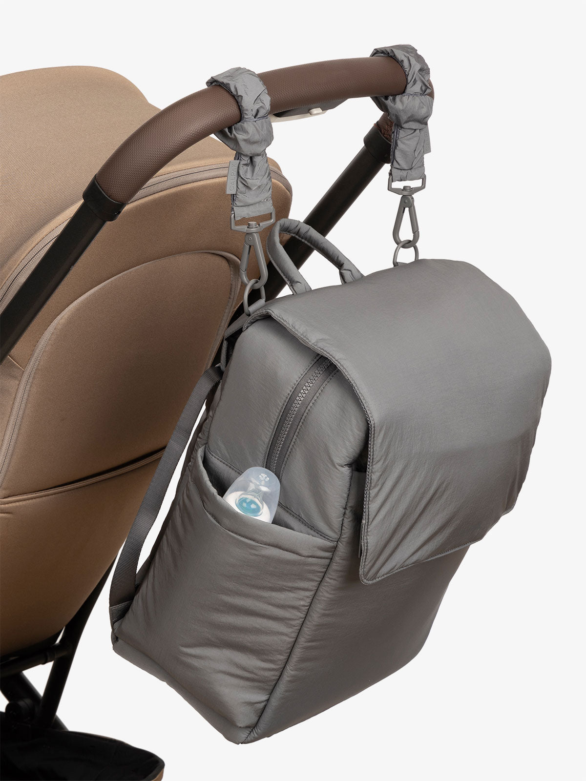 CALPAK Diaper Backpack with Laptop Sleeve attached to stroller by CALPAK Stroller Straps in slate; BPB2401-SLATE, BBPB2401-SLATE