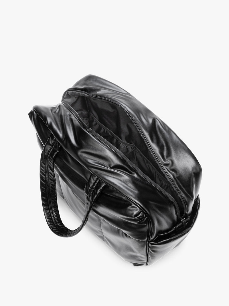Side view showing inside of Black CALPAK Luka Large Duffel in vegan leather with dual top handles, shown against a plain white background