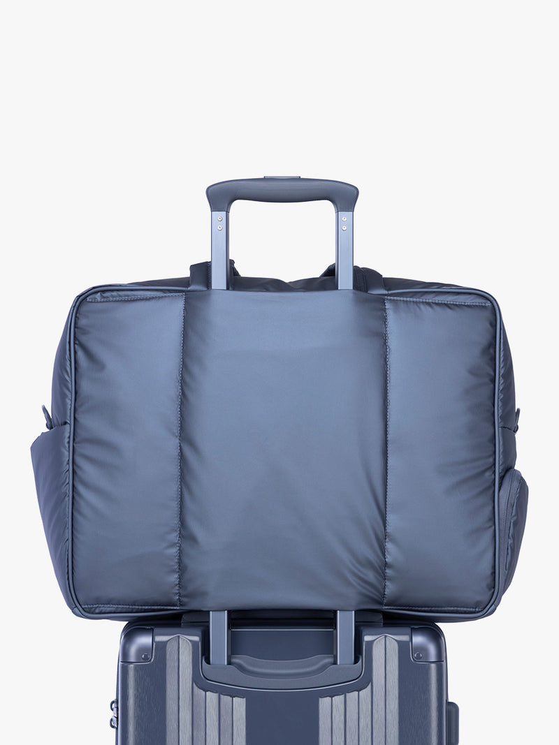Luggage trolley sleeve of CALPAK Luka Large Duffel in dark blue metallic material in Metallic Indigo