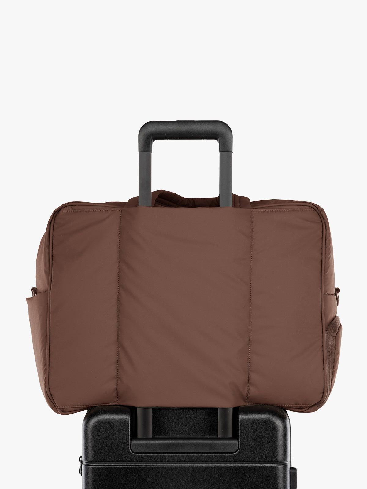 Backside Luggage Trolley sleeve feature of the CALPAK Luka Large Duffel in brown Walnut front view with a grey studio background; DLL2201-WALNUT