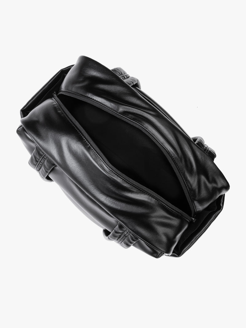 Top view with zipper opened of Black vegan leather CALPAK Luka Mini Duffel with dual top handles and side pockets, photographed against a clean white background