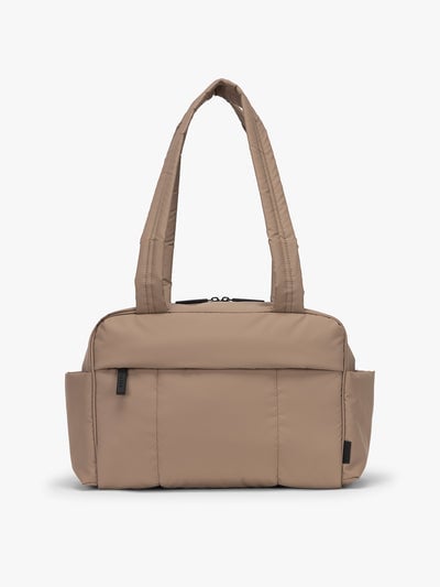 CALPAK Mini Duffel in brown Chocolate front view with puffy exterior, interior and exterior pockets, and padded shoulder straps; DLM2501-CHOCOLATE