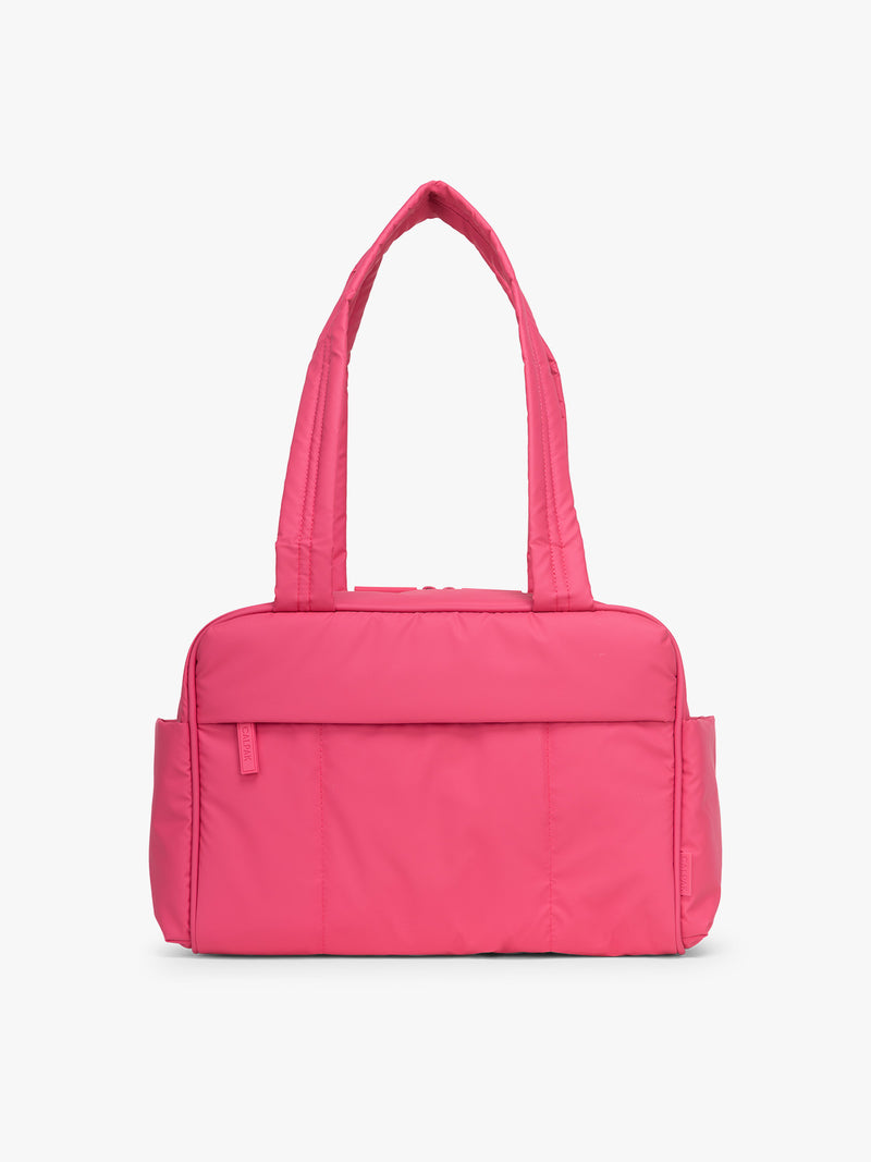 CALPAK Luka Mini Duffel in bright pink on a white background