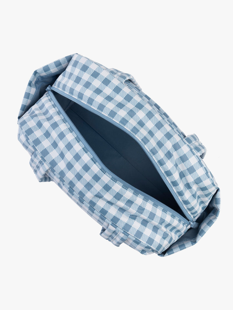 Opened view of CALPAK Luka Mini Duffel in white and blue gingham print in French Blue Gingham