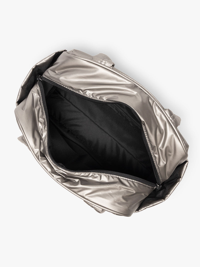 Opened interior of CALPAK Luka Mini Duffel in metallic grey on a white background