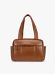 Honey brown vegan leather CALPAK Luka Mini Duffel with dual top handles and side pockets, photographed against a clean white background; DLM2501-HONEY-BROWN-PU