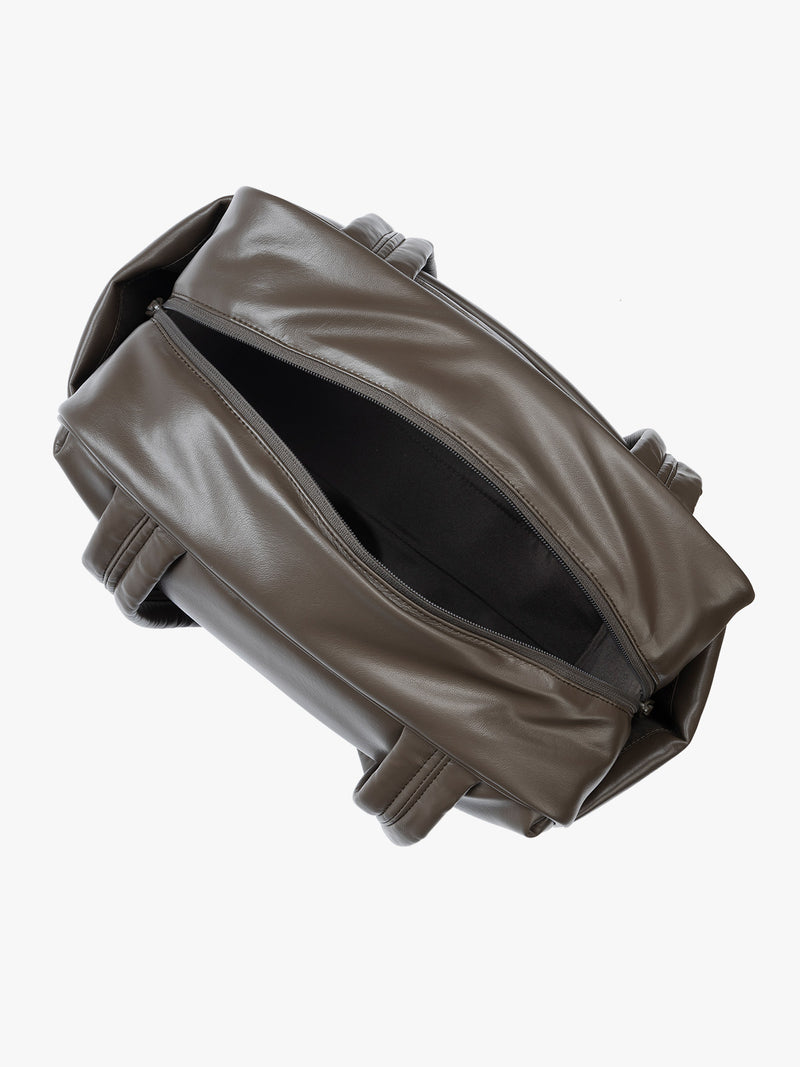 Top view with zipper open of a Dark brown Mushroom vegan leather CALPAK Luka Mini Duffel with dual top handles and side pockets, photographed against a clean white background