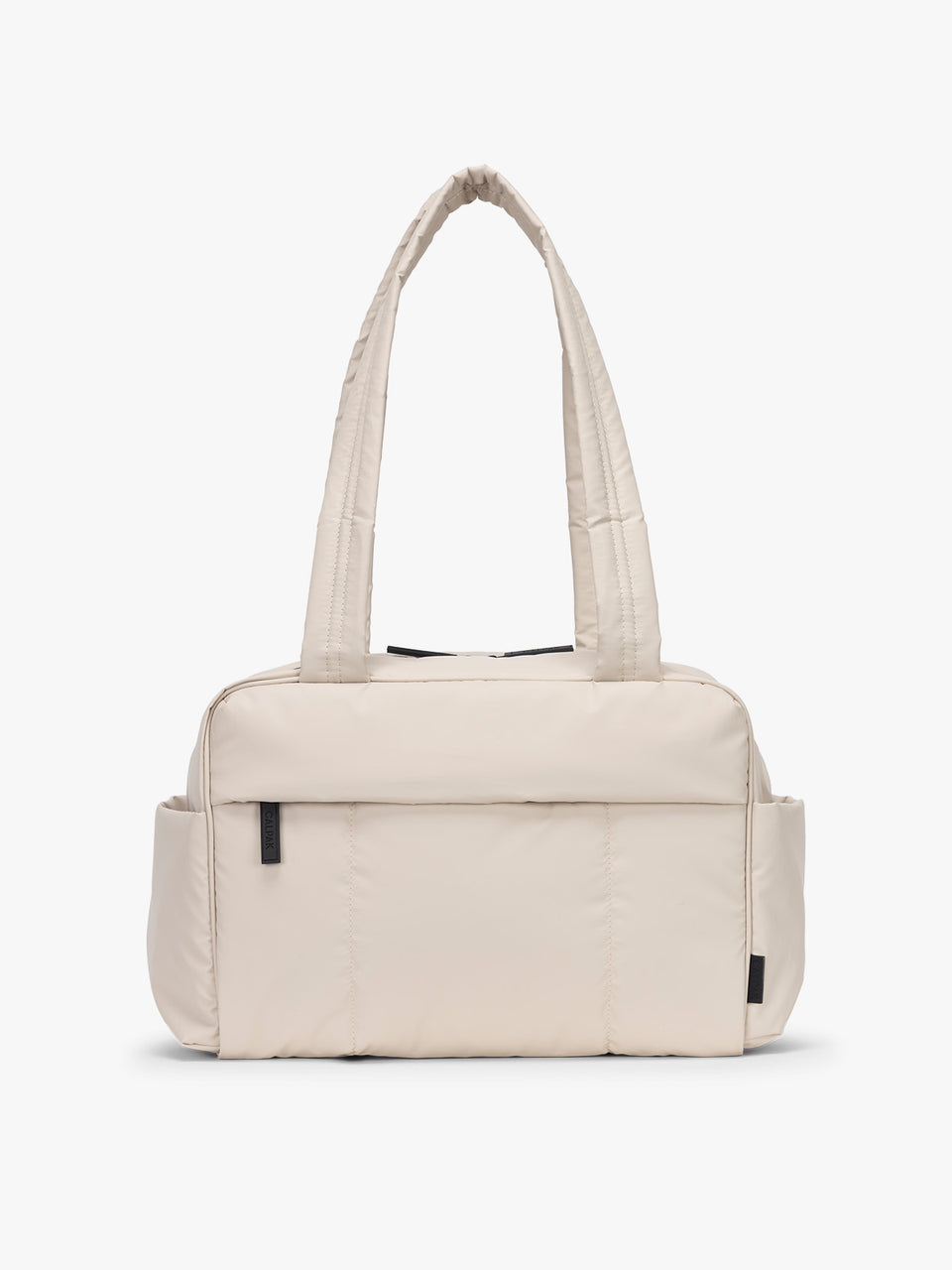 CALPAK Mini Duffel in white Oatmeal front view with puffy exterior, interior and exterior pockets, and padded shoulder straps; DLM2501-OATMEAL