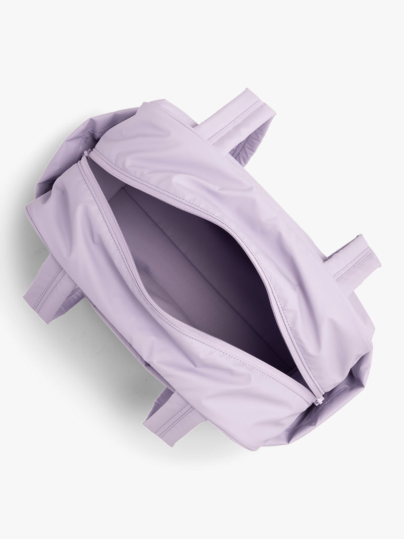 Opened interior of CALPAK Luka Mini Duffel in light purple Orchid on a white background