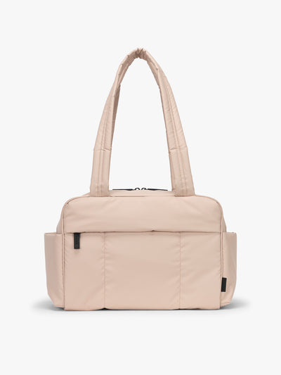 CALPAK Mini Duffel in light pink Rose Quartz with puffy exterior, interior and exterior pockets, and padded shoulder straps; DLM2501-ROSE-QUARTZ view 1