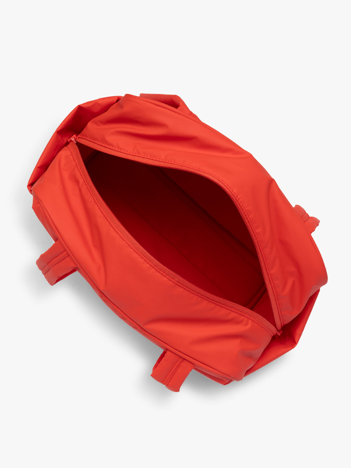 Opened CALPAK Luka Mini Duffel in red Tomato; DLM2501-TOMATO