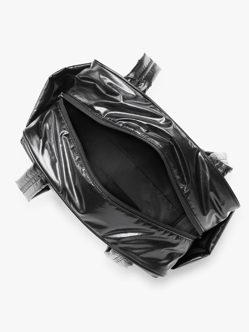 Opened view of CALPAK Luka Mini Duffel in shiny Glazed Black on a white background