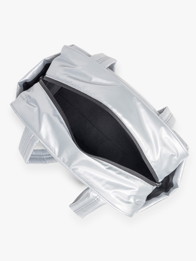 Opened view of CALPAK Luka Mini Duffel in shiny Silver on a white background