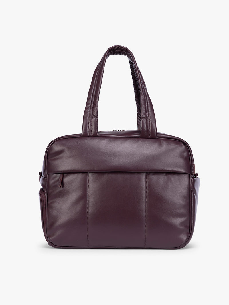 A dark burgundy CALPAK Luka Duffel in vegan leather with dual top handles and a front zippered pocket, photographed against a clean white background