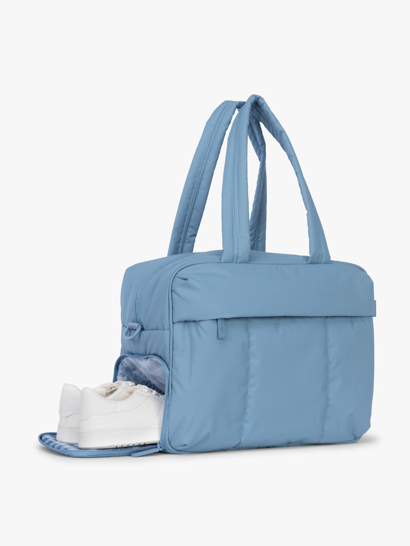 Shoe compartment of CALPAK Luka Duffel in light blue French Blue