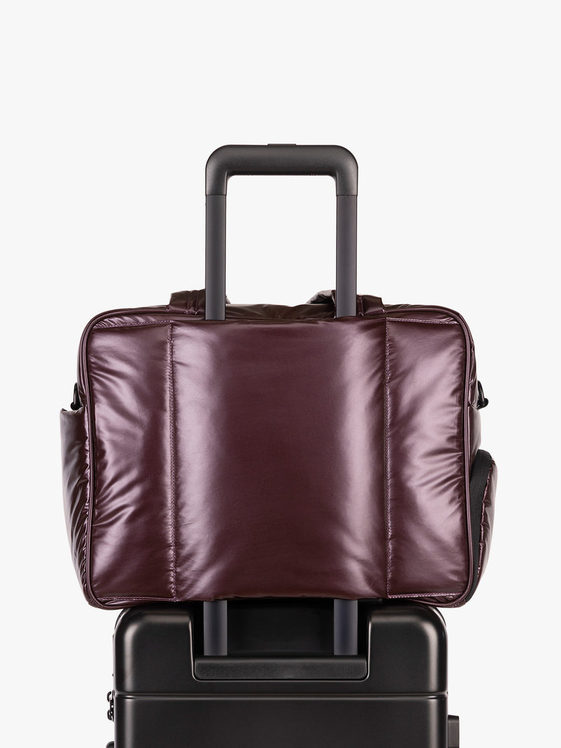 CALPAK Dark Cherry red Luka Duffel luggage trolley sleeve view on a white background