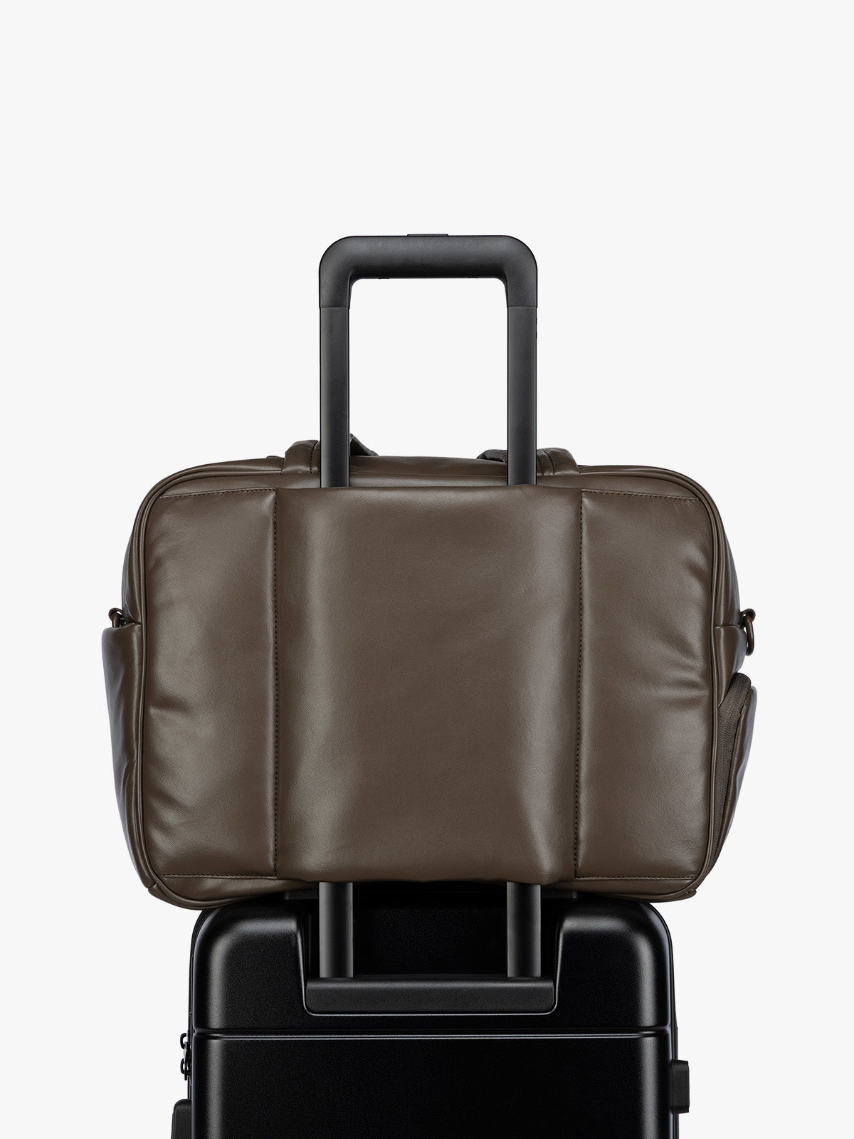 Luggage trolley sleeve of the A dark brown Mushroom CALPAK Luka Duffel in vegan leather with dual top handles and a front zippered pocket, photographed against a clean white background; DSM1901-MUSHROOM-PU