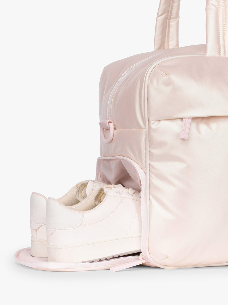 Shoe compartment of CALPAK Luka Duffel in light pink shiny Pearlescent